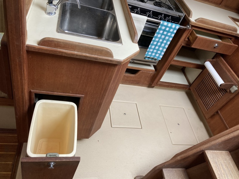 Galley lower storage areas and pull out trash bin