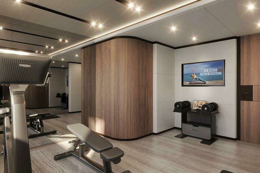 Luxurious gym interior on Majesty 145 yacht, featuring modern equipment and elegant wood paneling, 2026 model.