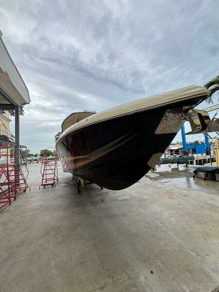 2013 Statement 35 Center Console boat on dry dock under cloudy sky.