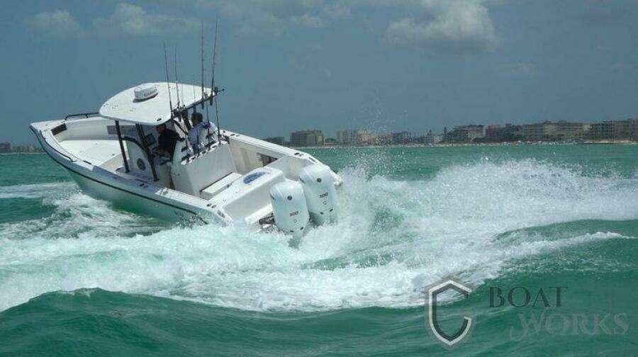 2022 CG Boat Works 35 M-Series navigating choppy waters near a coastal city.