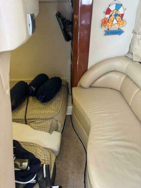 Interior cabin of a 2007 Monterey 350 Sport Yacht with cozy bedding and decor.