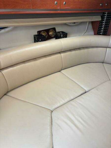 Interior of 2007 Monterey 350 Sport Yacht with beige seating and wooden cabinetry.