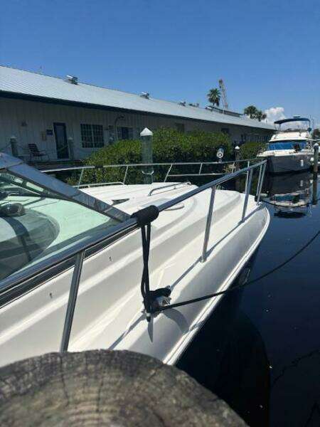 2007 Monterey 350 Sport Yacht with sleek dashboard and mooring rope, docked under clear blue sky.