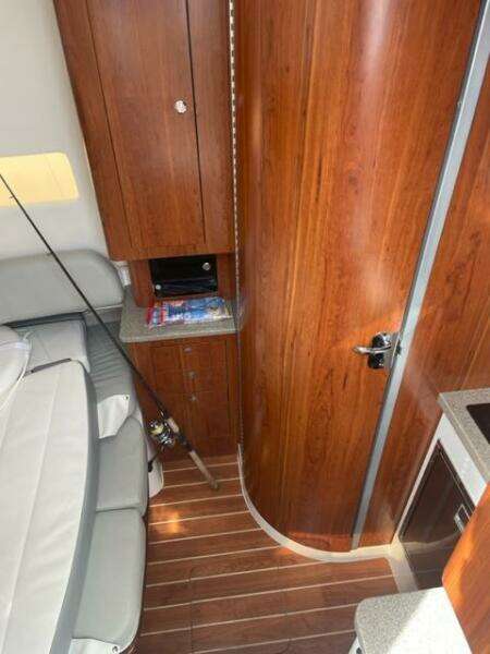 2018 Regulator 41 interior with wood paneling, seating, and fishing rod storage.