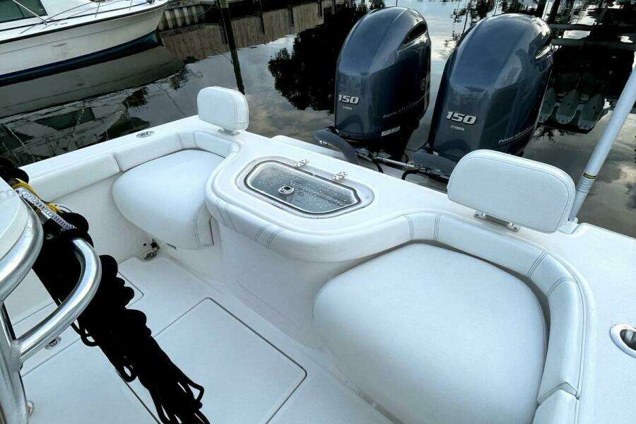 2023 Contender 24 Sport boat with dual Yamaha 150 engines, white seating, and livewell.