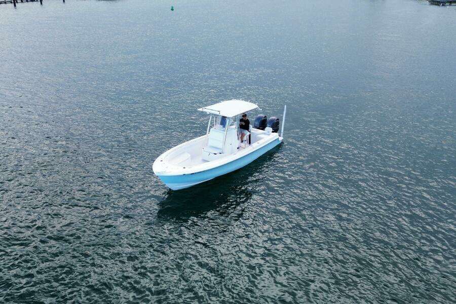 2023 Contender 24 Sport boat cruising on calm waters.