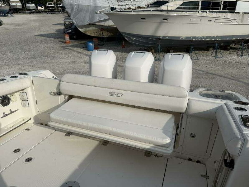 2014 Boston Whaler 350 Outrage cockpit with rear bench seat open, looking from port side