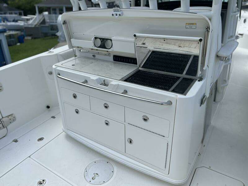 2014 Boston Whaler 350 Outrage Summer Kitchen Leaning Post open with Kenyon Grill open, looking from starboard side