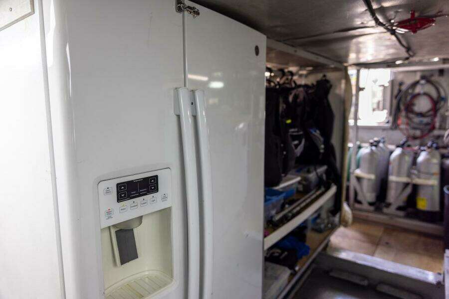 Refrigerator in a storage area with scuba gear and tanks, ABD 90 Explorer, 1996.