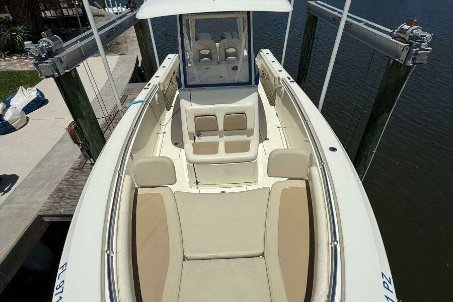 2015 Cobia 296 Center Console boat docked, featuring spacious seating and sleek design.