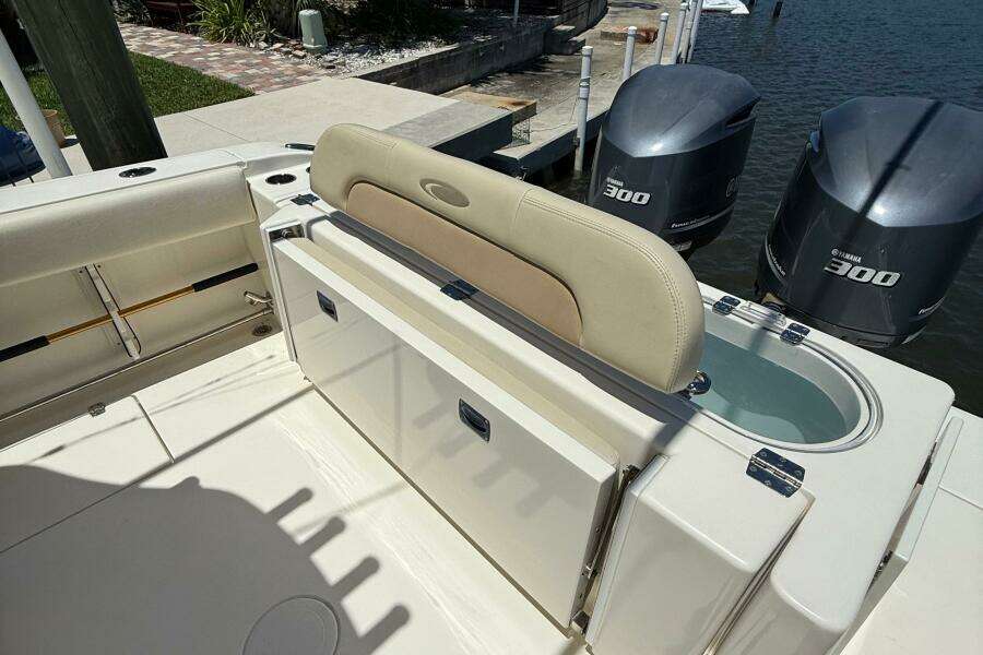 2015 Cobia 296 Center Console boat with Yamaha 300 engines, featuring a livewell and seating.