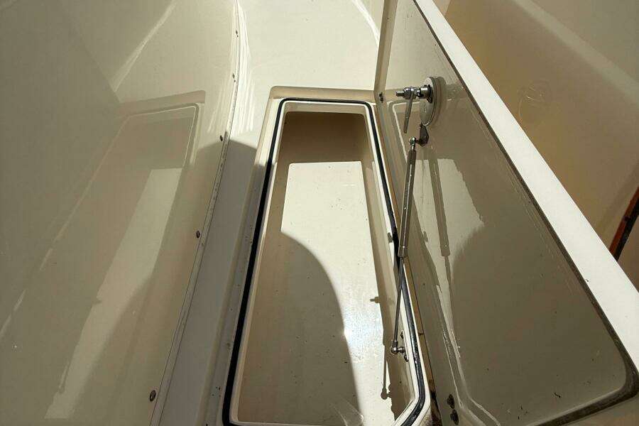 2015 Cobia 296 Center Console storage compartment, open lid, interior view.