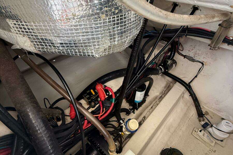 Engine compartment of a 2015 Cobia 296 Center Console with wiring and components.