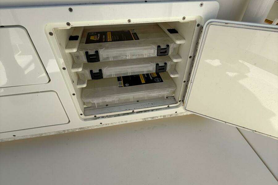 Storage compartment with tackle boxes on a 2015 Cobia 296 Center Console boat.