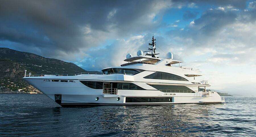 Luxurious 2020 Majesty 140 yacht cruising on serene waters under a cloudy sky.