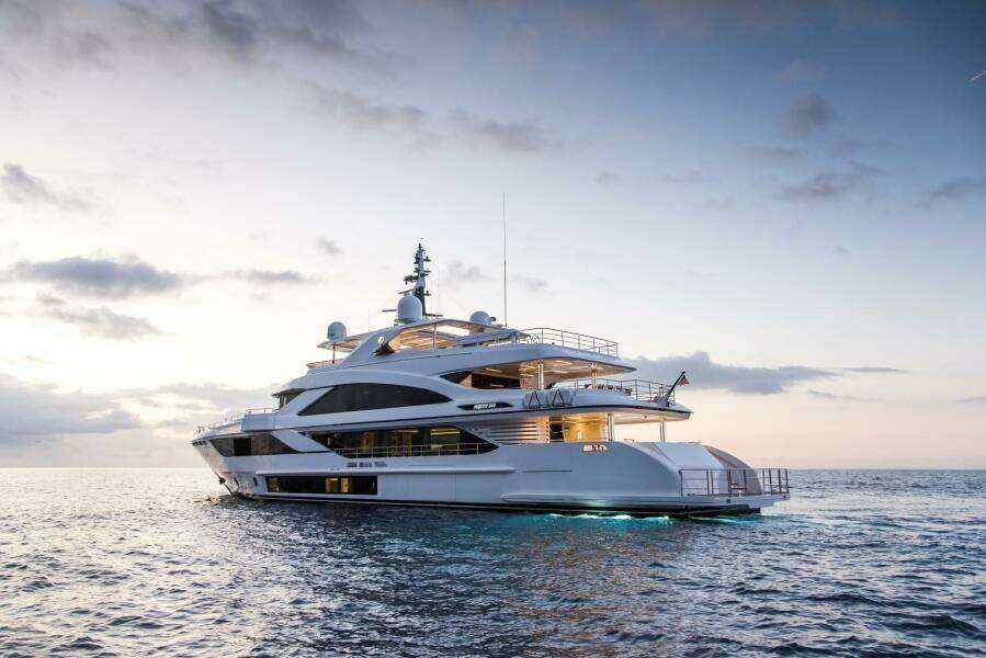 Luxury Majesty 140 yacht on serene ocean at sunset, 2020 model.