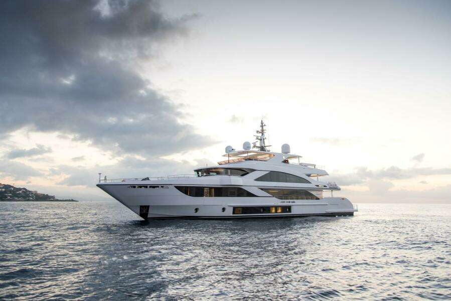 Luxury Majesty 140 yacht cruising at sunset, 2020 model.