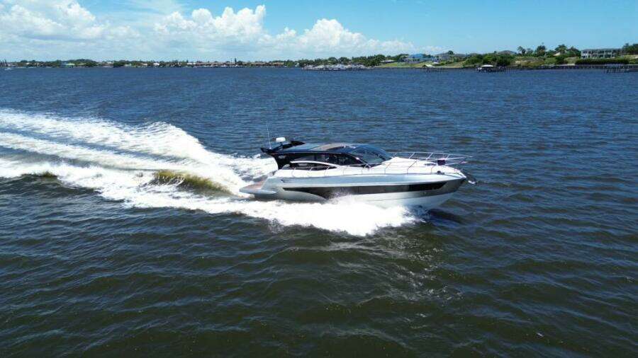 Luxury yacht Real 40 HT 2025 cruising on open water under clear skies.