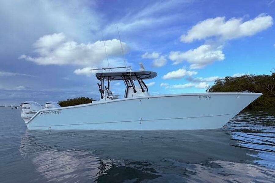 2019 Freeman 34 boat on calm water under a partly cloudy sky.