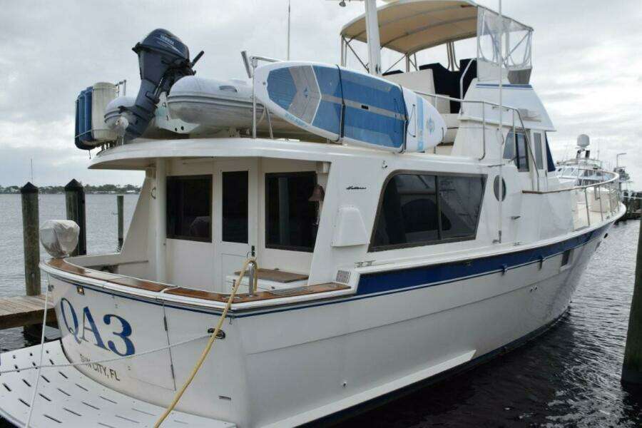 Hard bottom tender and paddleboard on flybridge with fender storage rack. Magna grill in rod holder mount.
