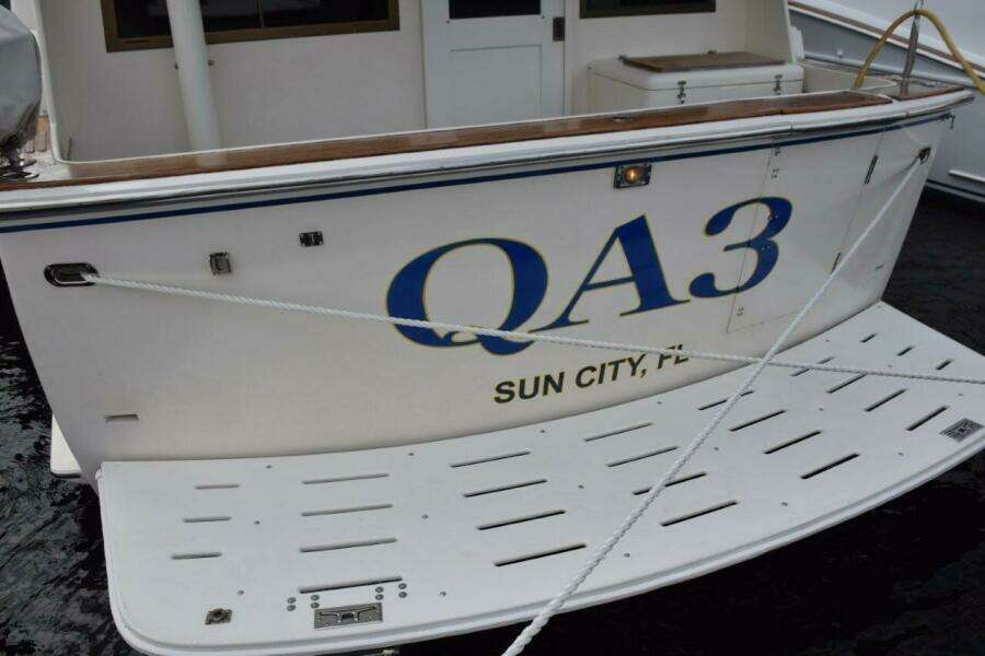 Cockpit with walk through transom door and fiberglass swim platform with ladder, Teak coverboards.