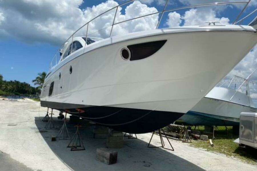 2014 Beneteau Gran Turismo 44 yacht on stands, clear sky background.