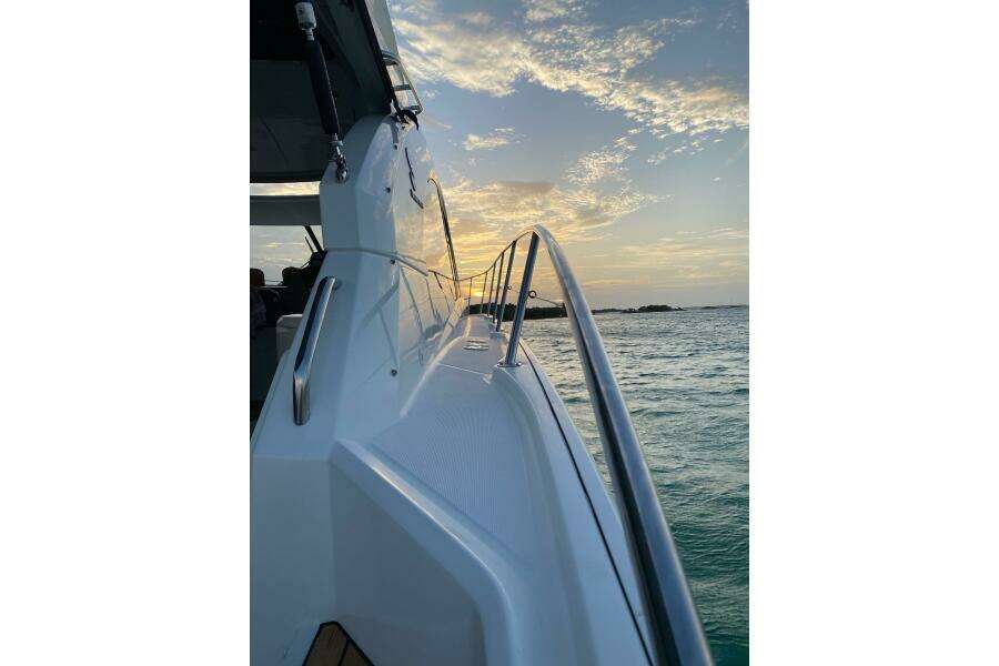 2014 Beneteau Gran Turismo 44 yacht at sunset on the ocean.