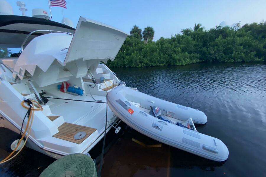 2014 Beneteau Gran Turismo 44 yacht with inflatable boat on calm water.