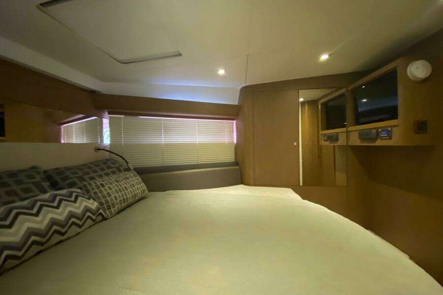 Luxurious cabin interior of 2014 Beneteau Gran Turismo 44 yacht with cozy bedding.