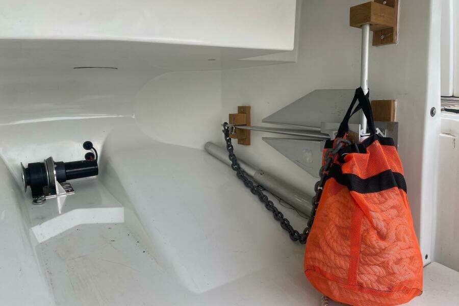 Storage compartment of 2014 Beneteau Gran Turismo 44 with anchor and orange mesh bag.