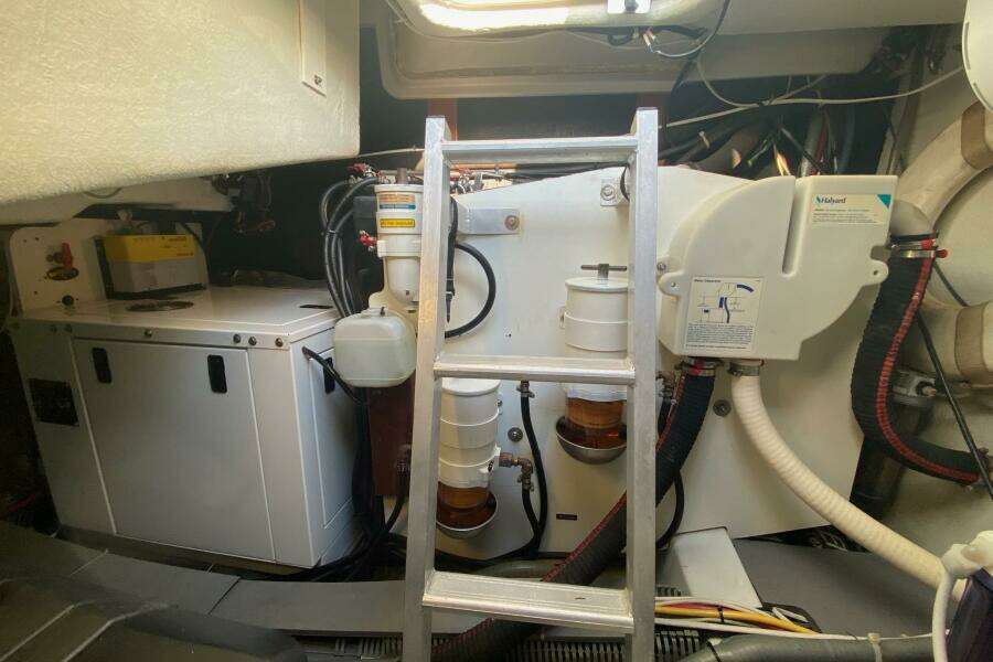 Engine room of a 2014 Beneteau Gran Turismo 44 with visible machinery and ladder.