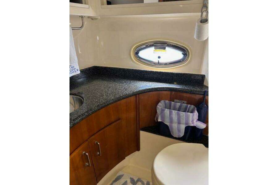 Luxurious bathroom in 2004 Carver 466 Motor Yacht with granite countertop and oval window. Luxurious bathroom in 2004 Carver 466 Motor Yacht with granite countertop and oval window.