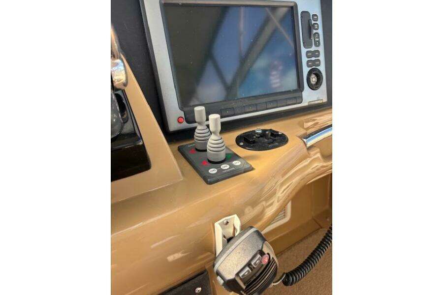 Control panel of 2004 Carver 466 Motor Yacht with navigation screen and joystick controls. Control panel of 2004 Carver 466 Motor Yacht with navigation screen and joystick controls.