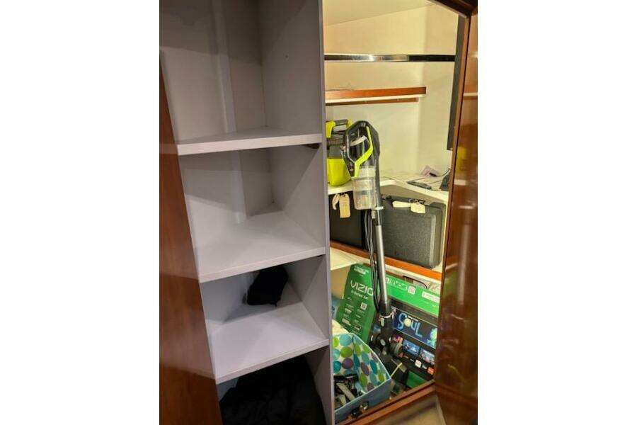 Storage area inside 2004 Carver 466 Motor Yacht with shelves and cleaning equipment. Storage area inside 2004 Carver 466 Motor Yacht with shelves and cleaning equipment.