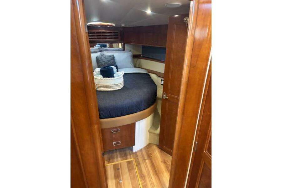 Luxurious cabin interior of 2004 Carver 466 Motor Yacht with wood finish and cozy bedding. Luxurious cabin interior of 2004 Carver 466 Motor Yacht with wood finish and cozy bedding.