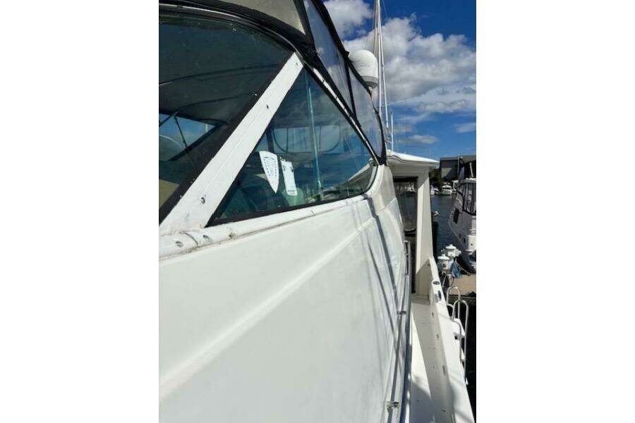 2004 Carver 466 Motor Yacht side view with clear skies and marina background. 2004 Carver 466 Motor Yacht side view with clear skies and marina background.