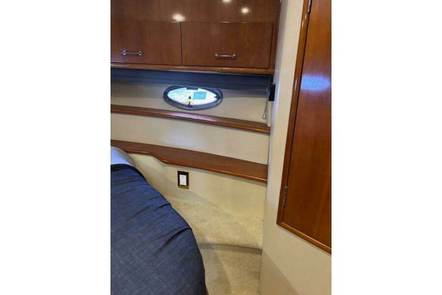 Interior of 2004 Carver 466 Motor Yacht with wood cabinetry and porthole window. Interior of 2004 Carver 466 Motor Yacht with wood cabinetry and porthole window.
