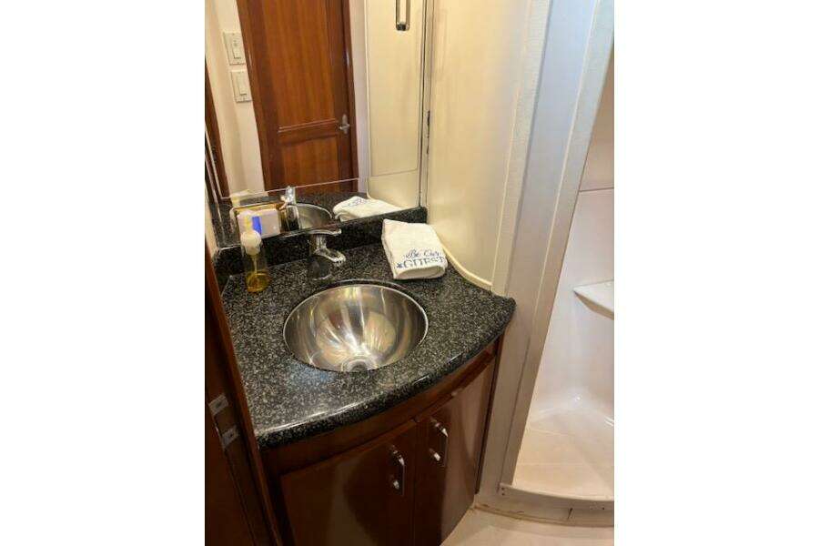 Luxurious bathroom in 2004 Carver 466 Motor Yacht with granite countertop and stainless steel sink. Luxurious bathroom in 2004 Carver 466 Motor Yacht with granite countertop and stainless steel sink.
