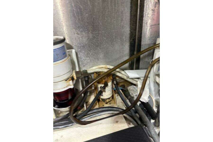 Engine room of 2004 Carver 466 Motor Yacht with visible fuel filter and hoses. Engine room of 2004 Carver 466 Motor Yacht with visible fuel filter and hoses.
