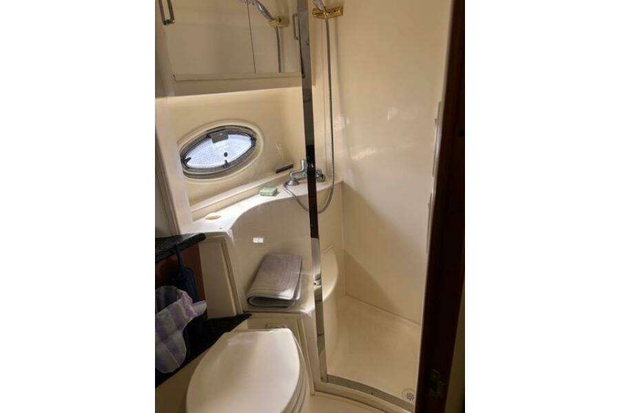 Bathroom interior of 2004 Carver 466 Motor Yacht with shower and porthole window. Bathroom interior of 2004 Carver 466 Motor Yacht with shower and porthole window.