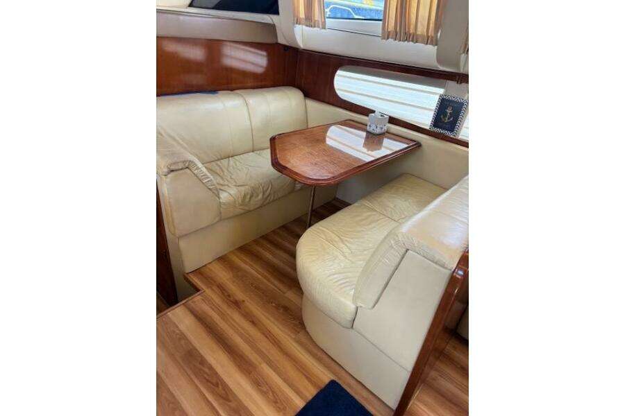 2004 Carver 466 Motor Yacht interior with leather seating and wooden table. 2004 Carver 466 Motor Yacht interior with leather seating and wooden table.