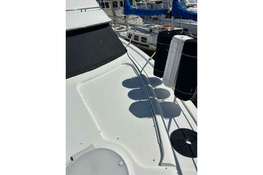 2004 Carver 466 Motor Yacht deck with fenders and railing in marina. 2004 Carver 466 Motor Yacht deck with fenders and railing in marina.