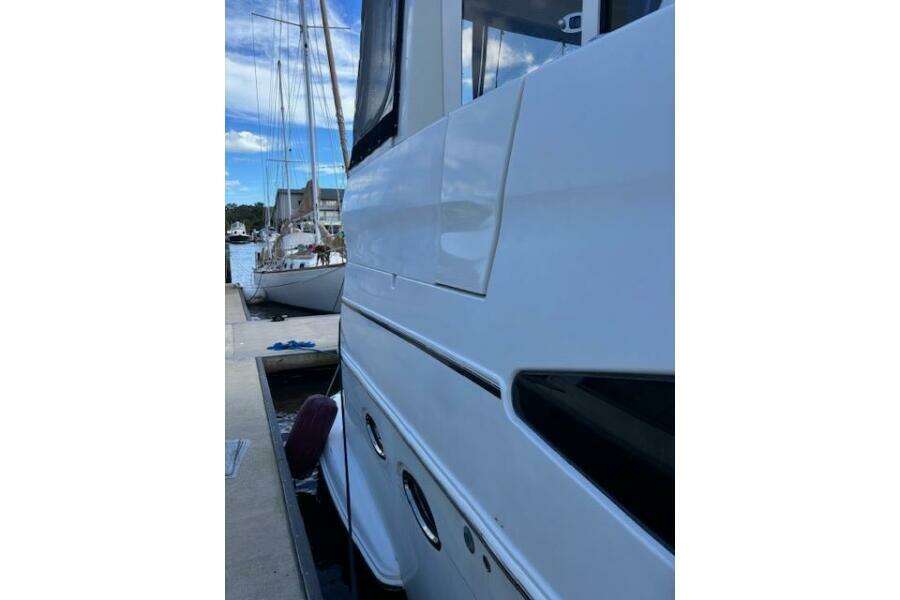 Side view of a 2004 Carver 466 Motor Yacht docked at a marina. Side view of a 2004 Carver 466 Motor Yacht docked at a marina.