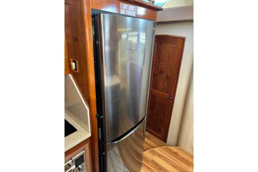 Stainless steel refrigerator in 2004 Carver 466 Motor Yacht interior, featuring wood accents. Stainless steel refrigerator in 2004 Carver 466 Motor Yacht interior, featuring wood accents.