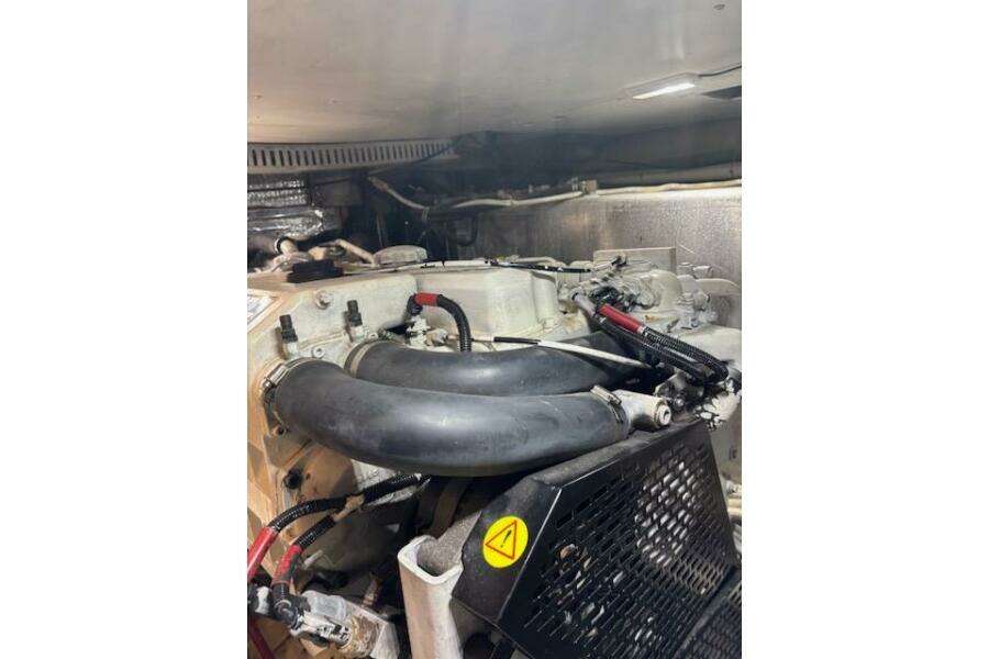 Engine compartment of a 2004 Carver 466 Motor Yacht, featuring hoses and mechanical components. Engine compartment of a 2004 Carver 466 Motor Yacht, featuring hoses and mechanical components.