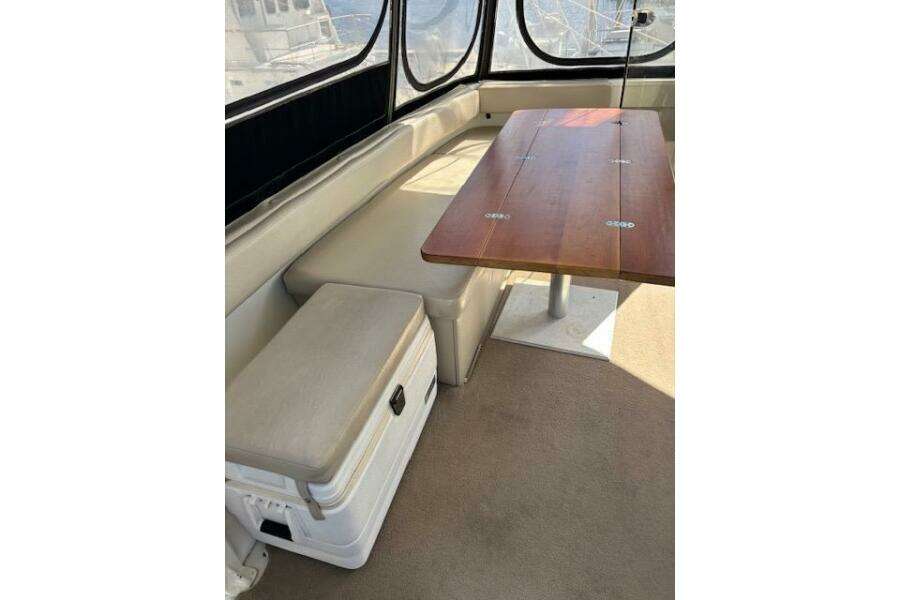 Interior of 2004 Carver 466 Motor Yacht with seating and wooden table. Interior of 2004 Carver 466 Motor Yacht with seating and wooden table.