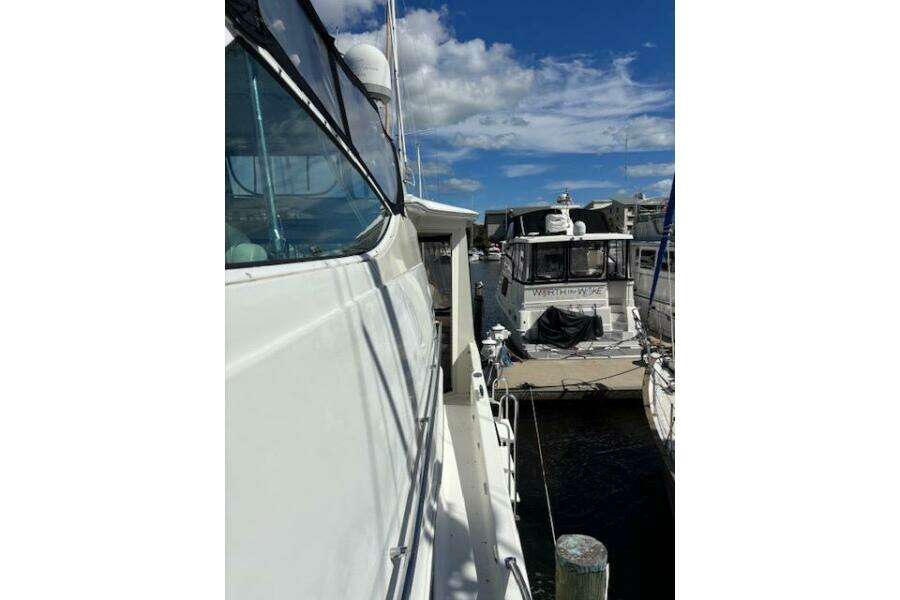 2004 Carver 466 Motor Yacht docked at marina under blue sky. 2004 Carver 466 Motor Yacht docked at marina under blue sky.
