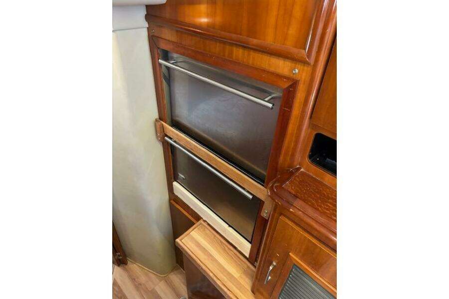 2004 Carver 466 Motor Yacht interior with stainless steel appliances and wooden cabinetry. 2004 Carver 466 Motor Yacht interior with stainless steel appliances and wooden cabinetry.