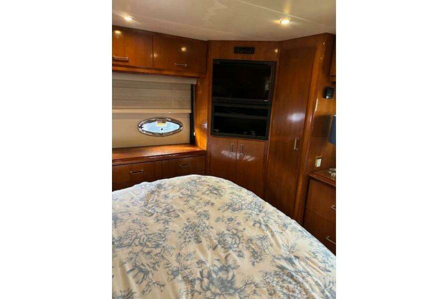 Luxurious interior of 2004 Carver 466 Motor Yacht with wood cabinetry and floral bedding. Luxurious interior of 2004 Carver 466 Motor Yacht with wood cabinetry and floral bedding.