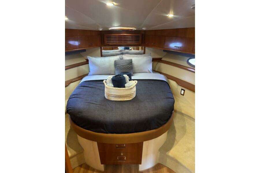 Luxurious bedroom interior of 2004 Carver 466 Motor Yacht with elegant bedding and wood accents. Luxurious bedroom interior of 2004 Carver 466 Motor Yacht with elegant bedding and wood accents.